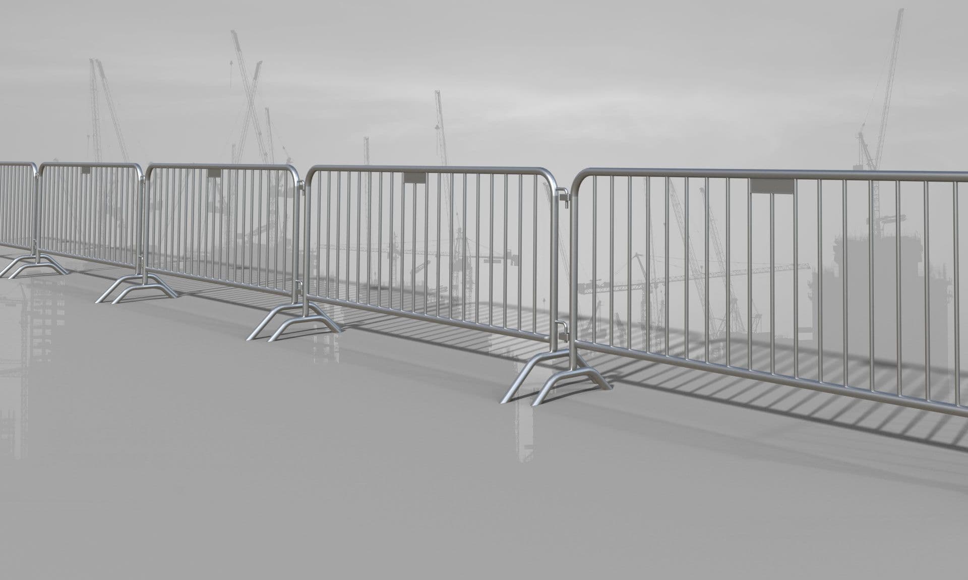 Rij dranghekken met op de achtergrond de skyline van een bouwplaats