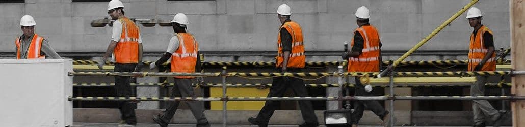 Werklieden in een oranje hesje op de bouw