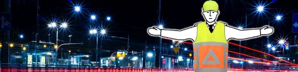 Een verkeersregelaar met op de achtergrond een stad in duisternis